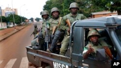 FILE - African Union MISCA troops from Cameroon patrol in Bangui, Central African Republic, May 29, 2014.