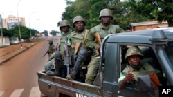 FILE - African Union troops from Cameroon patrol in Bangui, Central African Republic, May 29, 2014. Border communities in Cameroon are asking the government to authorize armed groups to fight C.A.R. rebels, as abductions of people and cattle have risen in the past two years.