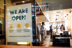 FILE - A sign advertises a restaurant opening in Santa Monica, Calif., March 16, 2021.