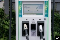 A charging station with Combined Charging System (CCS) plugs is seen in Anaheim, Calif., Friday, June 9, 2023. Owners of General Motors and Ford electric vehicles will be able charge at many of Tesla's large network of stations across the U.S. starting next year. (AP Photo/Jae C. Hong)