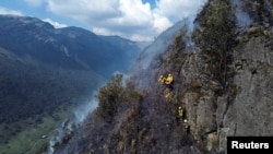 A drone views shows firefighters while they work to extinguish a wildfire at Cajas National Park in Cuenca, Ecuador, Nov. 17, 2024. 