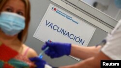 A sign reading "Vaccination" is pictured as Spain resumes vaccination with AstraZeneca shots, amid the coronavirus outbreak, at Enfermera Isabel Zendal hospital in Madrid, Spain, March 24, 2021. 