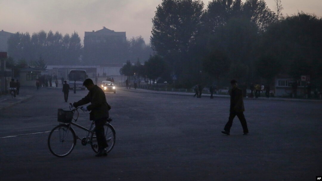 FILE - North Koreans make their way across an intersection at the end of a work day in Pyongyang, North Korea.
