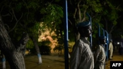 A handout photo taken and released on July 1, 2014 by the African Union-United Nations Information Support Team shows members of the Somali Police Force standing guard during an Independence Day ceremony in Mogadishu, Somalia. 