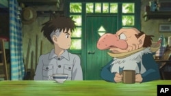 This image released by GKIDS shows Mahito Maki, voiced by Luca Padovan in English and Soma Santoki in Japanese, left, and Grey Heron, voiced by Robert Pattinson in English and Masaki Suda in Japanese, in a scene from Hayao Miyazaki’s “The Boy And The Heron." 
