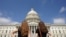 Women gaze at the dome of the US Capitol, days after the removal of security fencing which was placed around the complex after the Jan. 6 attack, in Washington, July 12, 2021. 