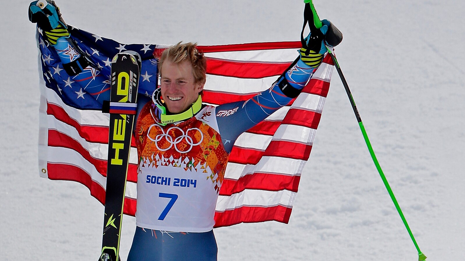 Men's giant slalom gold medalist Ted Ligety of the United States poses for photographers on the podium at the Sochi 2014 Winter Olympics, in Krasnaya Polyana, Russia, Feb. 19, 2014.