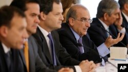 Humberto de la Calle, fourth from left, the chief of Colombia's government negotiation team with rebels of the Revolutionary Armed Forces of Colombia, FARC, speaks during a press conference at the presidential palace in Bogota, Colombia, Aug. 29, 2016. 