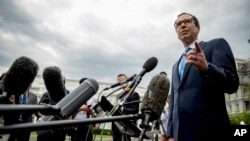 FILE - Treasury Secretary Steve Mnuchin takes a question from a reporter outside the West Wing of the White House in Washington, Sept. 9, 2019.