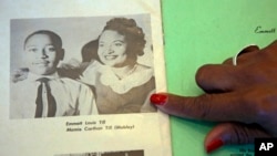 Deborah Watts of Minneapolis, points out a widely seen 1950s photograph of her cousin Emmett Till and his mother, Mamie Till Mobley, during a visit to Jackson, Miss., Aug. 27, 2015.