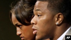 FILE - Janay Rice, left, looks on as her husband, Baltimore Ravens running back Ray Rice, speaks to the media during a news conference in Owings Mills, Md.