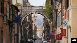 A view of an empty street, in Rome, March 21, 2020. Mayors of many towns in Italy are asking for ever more stringent measures on citizens' movements to help contain the surging infections of the coronavirus.