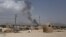 Smoke rises into the air after Taliban militants launched an attack on the Afghan provincial capital of Ghazni, Aug. 10, 2018.
