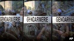 Guinean police take position outside the Independent Election Commission building in Conakry, Guinea, Sunday, Nov. 14, 2010, after the representative of presidential candidate Cellou Dalein Diallo suspended his participation in the vote tallying process.