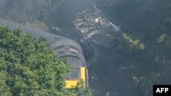 Derailed carriages are seen at the scene of a train crash near Stonehaven in northeast Scotland, Aug. 12, 2020.