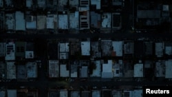 A drone view shows a community as Puerto Ricans were without electricity early on New Year's Eve after a grid failure left nearly all of the island without power, in San Juan, Puerto Rico, Dec. 31, 2024.