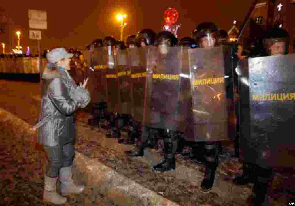 An opposition supporter appeals to riot policemen during a rally in the Belarusian capital, Minsk, late Sunday, Dec. 19, 2010. Thousands of opposition supporters in Belarus tried to storm the main government building to protest what the opposition claims 