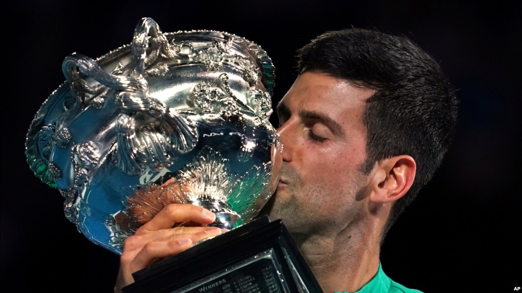 FILE - Serbia's Novak Djokovic kisses the Norman Brookes Challenge Cup after defeating Russia's Daniil Medvedev in the men's singles final at the Australian Open tennis championship in Melbourne, Australia Feb. 21, 2021.(AP Photo/Mark Dadswell)