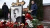 A man lays flowers at the grave of Russian opposition leader Alexey Navalny at the Borisovo cemetery in Moscow on Feb. 16, 2025, marking the first anniversary of his death in an Arctic colony under murky circumstances.