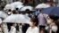People wearing a protective face mask to help curb the spread of the coronavirus walk at Shibuya pedestrian crossing, July 9, 2020, in Tokyo.