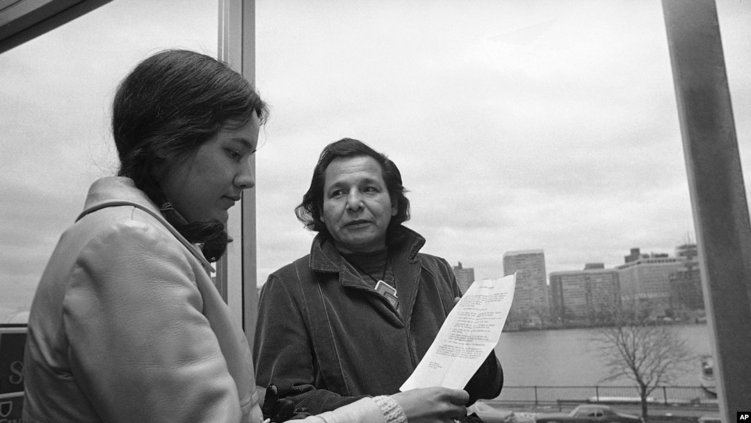 FILE - in this Nov. 4, 1971 photo, Eddie Benton-Benai shows a prayer he wrote to Linda Jeffers, of Vineyard Haven, Martha's Vineyard, Mass., a member of the Wampanoag Tribe in Cambridge, Mass.