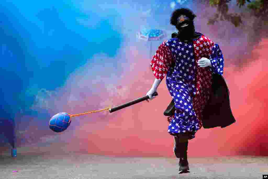 A member of a “bate-bola” or ball hitters group runs past during a brief appearance as part of a Carnival tradition despite COVID-19 restrictions in Rio de Janeiro, Brazil, Feb. 13, 2021.