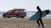 A San Francisco Surf Rescue team evacuates surfers from San Francisco's Ocean Beach in case of a tsunami on Dec. 5, 2024. Area residents were notified of a chance of a tsunami after a reported earthquake in Northern California.