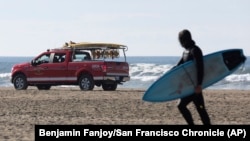 A San Francisco Surf Rescue team evacuates surfers from San Francisco's Ocean Beach in case of a tsunami on Dec. 5, 2024. Area residents were notified of a chance of a tsunami after a reported earthquake in Northern California.