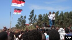 FILE - Merara Gudina, top left, the chairman of the Oromo people's Congress addresses a crowd of supporters during a political rally in in his home town of Tokkee, May 15, 2010. 