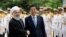 Japanese Prime Minister Shinzo Abe, center, shakes hands for the cameras with Iranian President Hassan Rouhani, during the official arrival ceremony, at the Saadabad Palace in Tehran, Iran, June 12, 2019. 