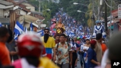 FILE - Anti-government demonstrators march against President Daniel Ortega and for the release of all political prisoners, in Leon, Nicaragua, July 28, 2018. 