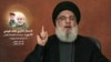 Sebuah gambar yang diambil dari TV al-Manar milik Hizbullah tanggal 10 Juli 2024, menunjukkan pemimpin Hizbullah Hassan Nasrallah memberikan pidato yang disiarkan televisi dari lokasi yang dirahasiakan di Lebanon.