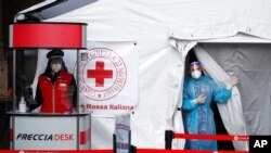 Paramedics wait to perform COVID-19 tests on passengers inside a tent at Milan's central railway station at the inauguration of a Rome-Milan Trenitalia train connection where only negative-tested passengers are allowed, April 16, 2021.