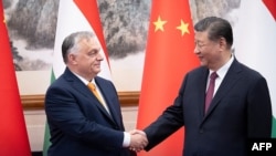 This handout from the social media platform X account of Hungary's Prime Minister Viktor Orban @PM_ViktorOrban posted on July 8, 2024, shows Orban, left, shaking hands with China's President Xi Jinping in Beijing.