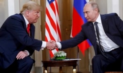 FILE - U.S. President Donald Trump, left, and Russian President Vladimir Putin shake hands at the beginning of a their bilateral meeting at the Presidential Palace in Helsinki, Finland, July 16, 2018.