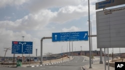 This March 19, 2020 photo, shows an empty road leading to departures at the Cairo International Airport during a travel ban due to the coronavirus outbreak, in Cairo, Egypt.