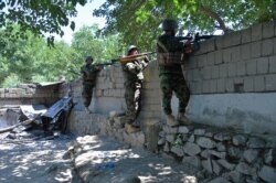 Members of Afghan security forces take their positions during a clash between Taliban and Afghan forces in Mihtarlam, the capital of Laghman province, on May 24, 2021.