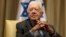 FILE - Former U.S. President Jimmy Carter sits prior to a meeting with Shimon Peres, then Israel's president, in Jerusalem, Oct. 21, 2012. 