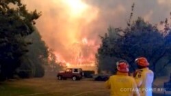 FILE PHOTO: Firefighters work at the scene of a bushfires in Bilpin, New South Wales, Australia in this still image from a social media video December 15, 2019. Andrew Mitchell/Cottage Point Rural Fire Brigade via REUTERS ATTENTION EDITORS - THIS…