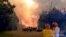 FILE - Firefighters work at the scene of a bushfire in Bilpin, New South Wales, Australia, in this still image from a social media video, Dec. 15, 2019. 