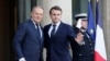 French President Emmanuel Macron welcomes Poland's Prime Minister Donald Tusk before an informal summit of European leaders to discuss the situation in Ukraine and European security at The Elysee Presidential Palace in Paris on Feb. 17, 2025. 