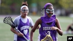 Fadumo Adan, a lacrosse player at Deering High School in Portland, Maine, wears a sports hijab provided by the school during practice in Portland, Maine. Deering High School is providing sport hijabs with the goal of making Muslim girls comfortable and boosting their participation in sports. (AP Photo/Robert F. Bukaty)