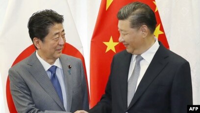 安倍习近平在俄会晤双方表示关系改善