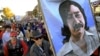 FILE - Marchers carry a large painting of jailed American Indian Leonard Peltier during a march for the National Day of Mourning in Plymouth, Mass, Nov. 22, 2001. United American Indians of New England held its first National Day of Mourning in 1970. 