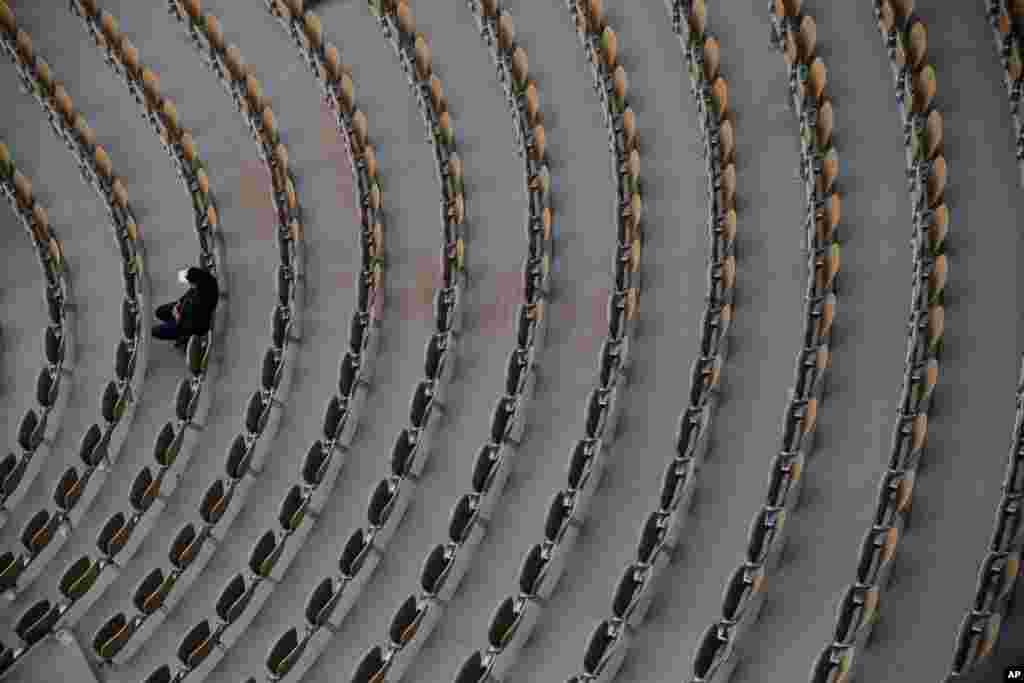 A lone spectator watches Sofia Kenin of the U.S. and Petra Kvitova of the Czech Republic in the semifinal match of the French Open tennis tournament at the Roland Garros stadium in Paris, France.