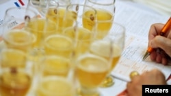 FILE - A jury member fills an evaluation sheet during the Brussels Beer Challenge in Brussels, Belgium, Nov. 4, 2016. 