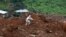 A rescue worker is seen at the scene of the mudslide in the mountain town of Regent, Sierra Leone, Aug. 16, 2017. 