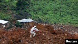 A rescue worker is seen at the scene of the mudslide in the mountain town of Regent, Sierra Leone, Aug. 16, 2017. 