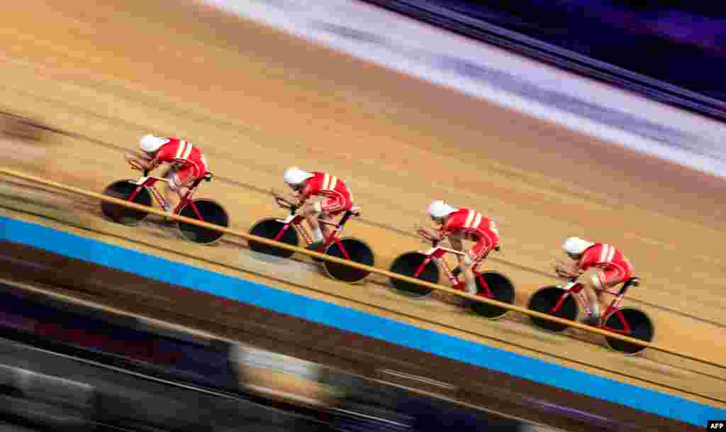 Denmark&#39;s team members — Lasse Norman Hansen, Julius Johansen, Frederik Rodenberg Madsen and Rasmus Pedersen — compete in the Men&#39;s Team Pursuit qualifying at the UCI track cycling World Championship in Berlin, Germany.