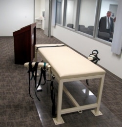 FILE - This Oct. 20, 2011 file photo shows the execution chamber at the Idaho Maximum Security Institution as Security Institution Warden Randy Blades look on in Boise, Idaho.